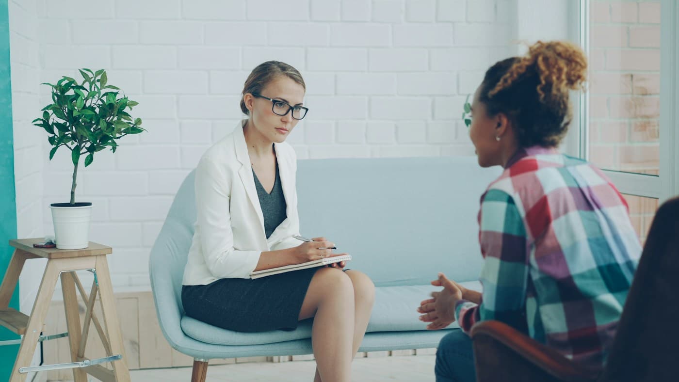 Stock photo: a care manager listening to a patient in a calm consultation room