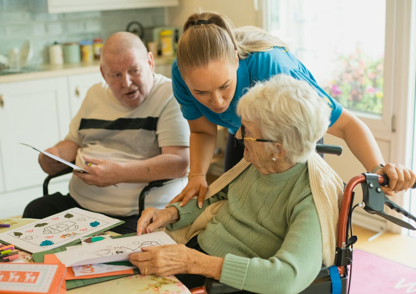 Stock photo: a caregiver leaning in to help an older woman at home